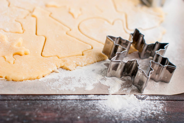 Cutting the gingerbread cookie dough for Christmas and New Year - Foto, afbeelding