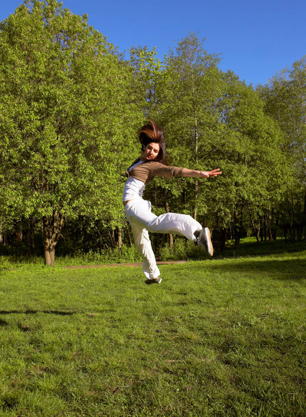 slim shaped beautiful girl jumping - Фото, изображение