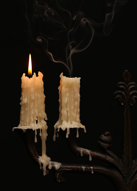 burning old candle vintage Silver bronze candlestick. Isolated Black Background. - Φωτογραφία, εικόνα