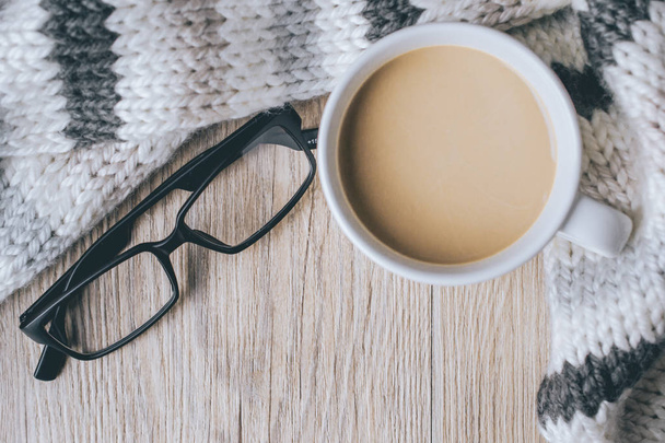coffee cup with glasses on the scarf and Wooedn in vintage tone - Foto, imagen
