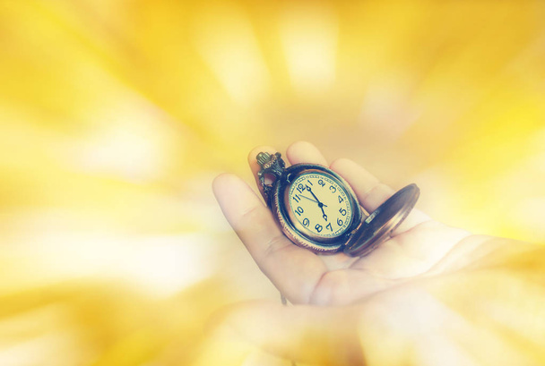 clock on hand and blank space area yellow golden background - Photo, Image
