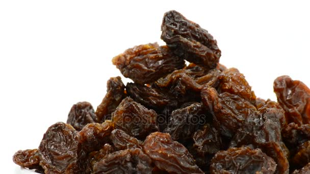 Raisins or dried grape fruit food gyrating on white background - Footage, Video
