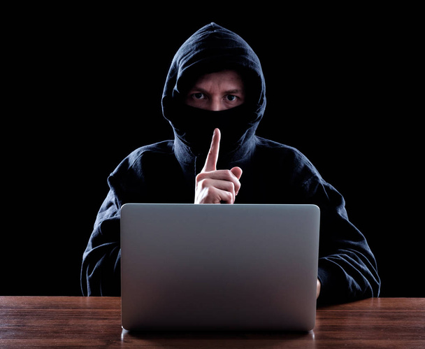 Computer hacker stealing data from laptop - 写真・画像