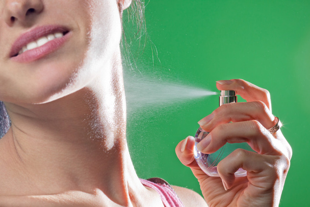 Beautiful young woman spraying parfume - Фото, зображення