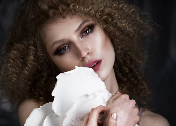 Beautiful girl with curly hair in lingerie and large flower. beauty face. - Foto, imagen