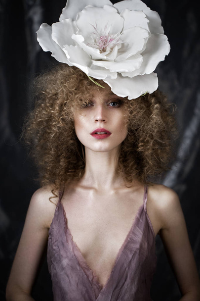 Beautiful girl with curly hair in lingerie and large flower. beauty face. - Фото, зображення