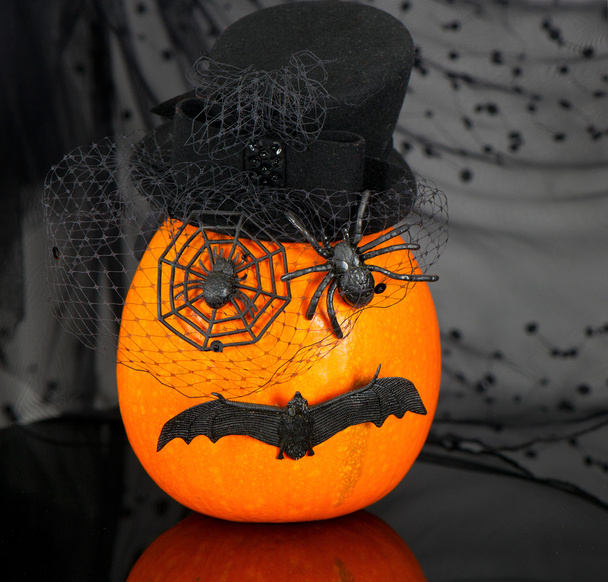 Funny pumpkin with spiders and bat on black - Zdjęcie, obraz
