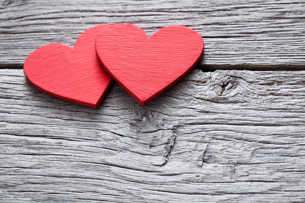Valentine day background, handmade hearts on wood with copy space - 写真・画像