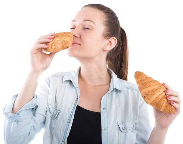 young girl with a croissant on a white background - Photo, Image
