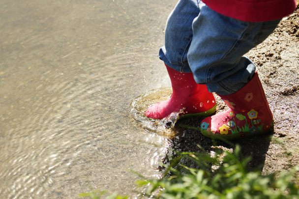 Legs of a little girl in rubber boots - Fotografie, Obrázek