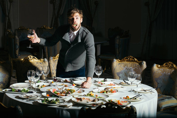 Surprised man eats after banquet - Photo, Image