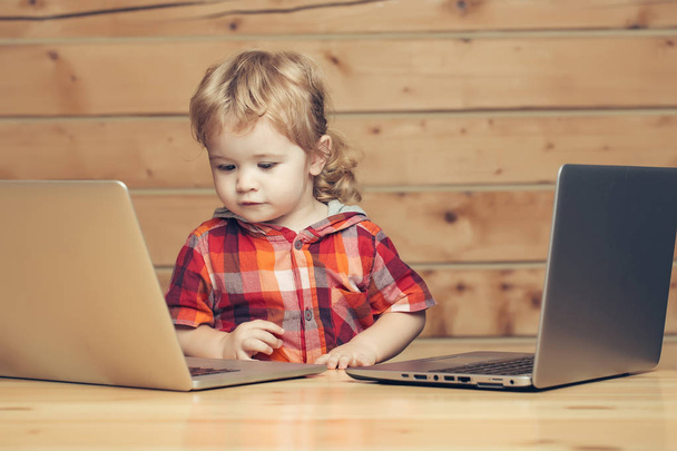 Cute boy plays on computers - Фото, изображение
