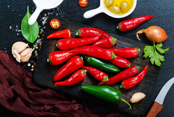aroma spices on a table, chilli peppers and aroma oil - 写真・画像