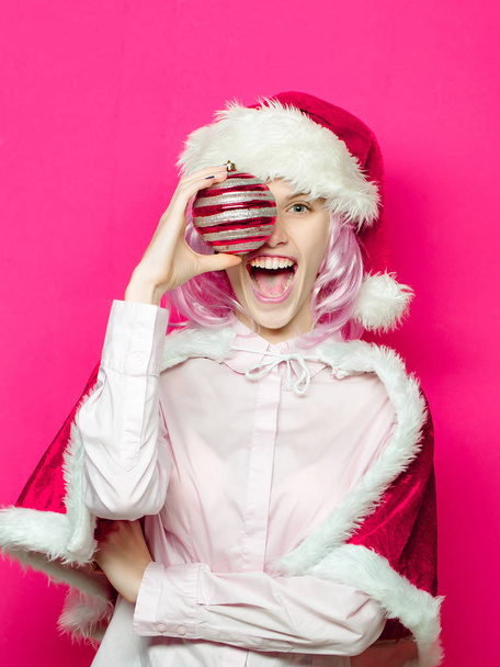 Excited girl with Christmas bauble - Фото, изображение