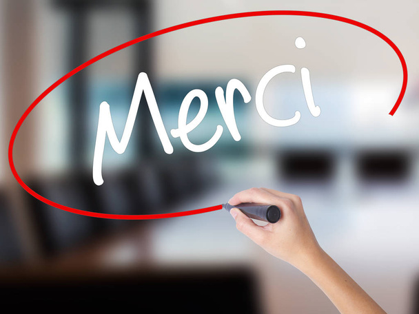Woman Hand Writing Merci  (Thank You In French) with a marker ov - Photo, Image