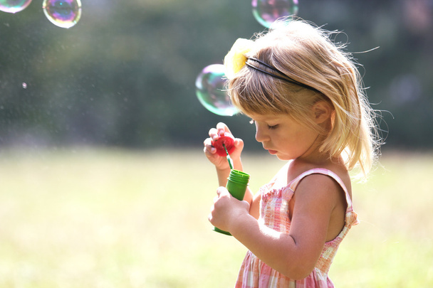 Little girl with soap bubbles - 写真・画像