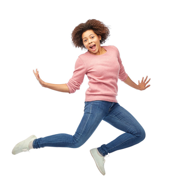 happy african american woman jumping over white - Foto, imagen