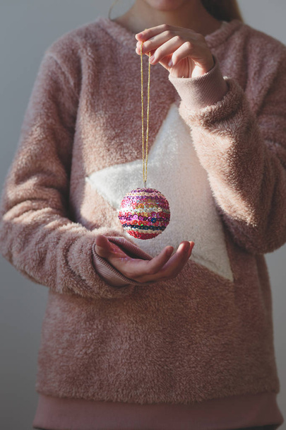 Girl holding her handmade Christmas ball - Foto, immagini