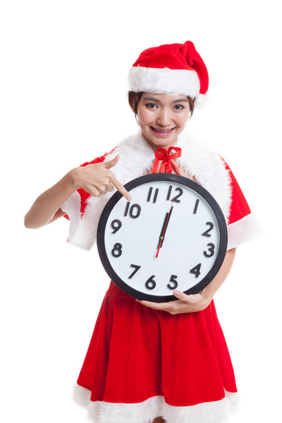 Asian Christmas Santa Claus girl  point to clock at midnight. - 写真・画像