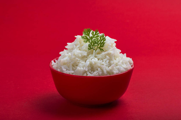 Cooked plain white basmati rice in a red bowl on red background - Φωτογραφία, εικόνα