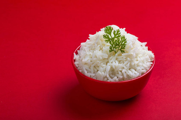 Cooked plain white basmati rice in a red bowl on red background - Foto, immagini