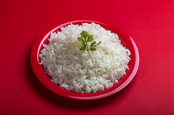 Cooked plain white basmati rice in a red plate on red background - Fotografie, Obrázek