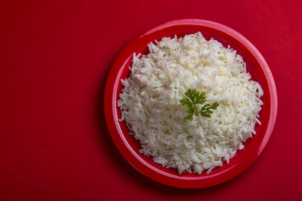 Cooked plain white basmati rice in a red plate on red background - Photo, Image