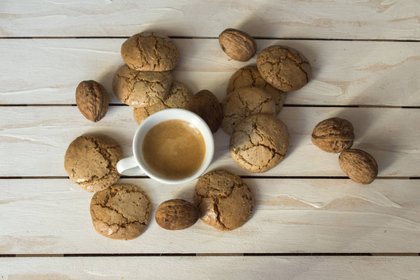 Cup of coffee, macaroons cookies  and walnut  - Фото, изображение
