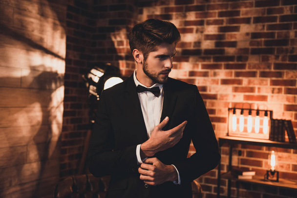 Handsome businessman in black suit fastening buttons on the slee - Φωτογραφία, εικόνα
