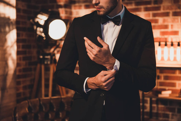 Close up of stylish man in black suit fastening cufflinks in lof - Foto, Imagem