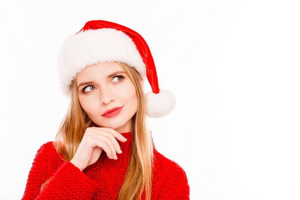 Pretty minded blonde in santa hat dreaming on white background - Foto, immagini