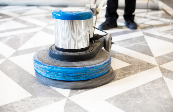 man polishing marble floor in office  - Foto, afbeelding