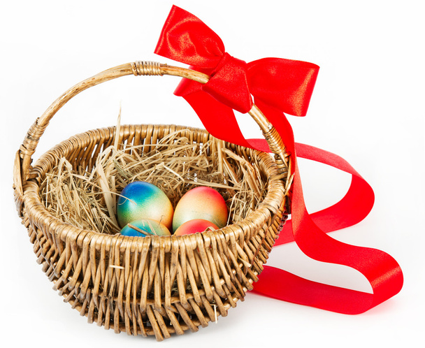 Colorful easter eggs in brown basket - Foto, imagen