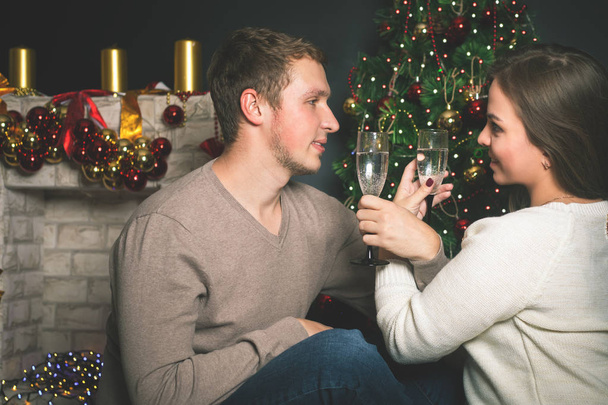 Couple young near decorated Christmas tree celebrating New Year - Foto, immagini