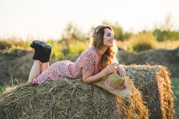 Beautiful woman on a haystack - Foto, imagen