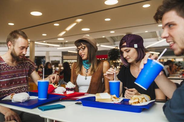 Friends having meals in cafe - Фото, изображение
