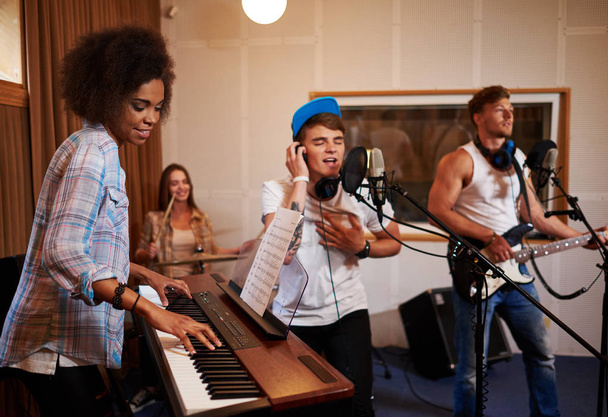 Multiracial music band performing in a recording studio - Φωτογραφία, εικόνα