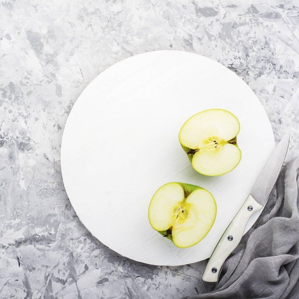 fashionable colors, the green apples on a gray marble table   white cutting board. Top view - Photo, Image