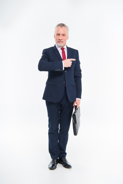 Smiling businessman pointing with finger  - Photo, Image