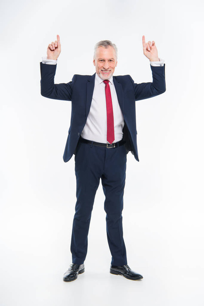 Smiling businessman pointing up - 写真・画像