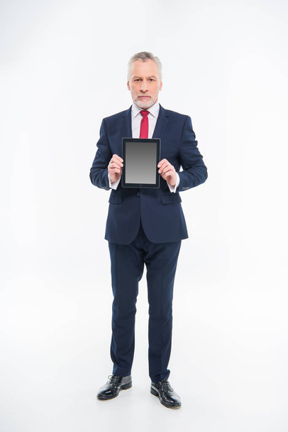 Businessman holding digital tablet - Fotó, kép