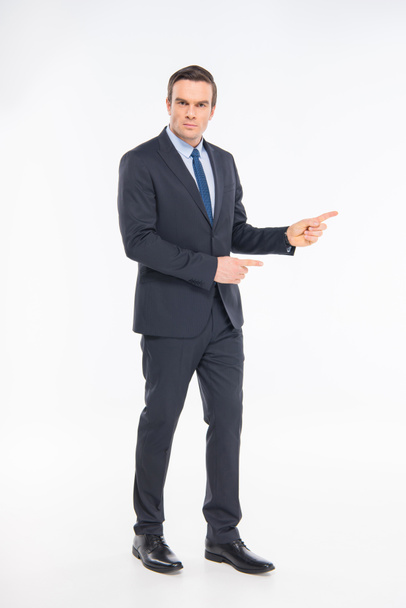 Professional businessman pointing  - Фото, изображение