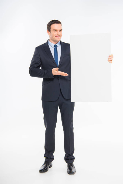 Businessman holding blank card - 写真・画像