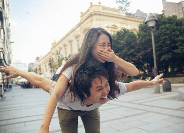 Couple of Asian Tourists performing piggyback - Fotó, kép