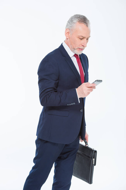 Businessman using smartphone - Fotó, kép