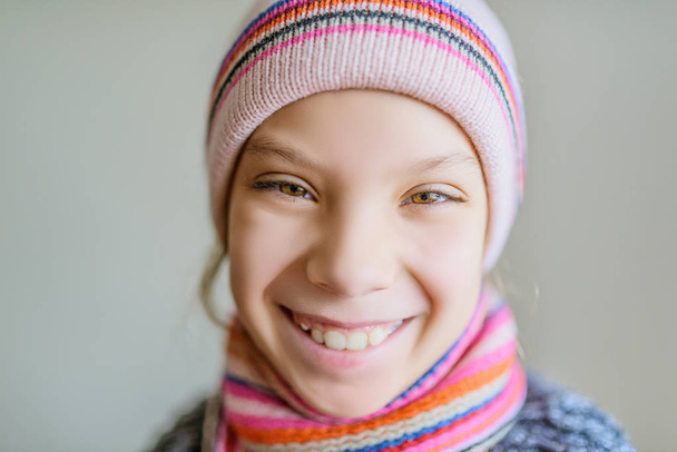 Little beautiful girl in winter hat and scarf - Фото, зображення