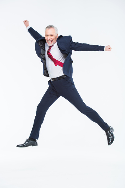 Mature businessman jumping - Photo, Image