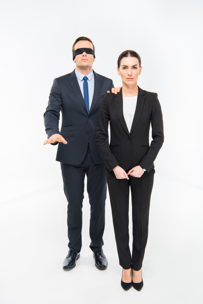 Businessman in blindfold and businesswoman - 写真・画像