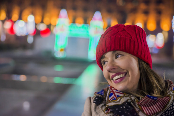Happy woman Feeling the urban christmas vibe at night. Surprised Christmas Woman - Φωτογραφία, εικόνα