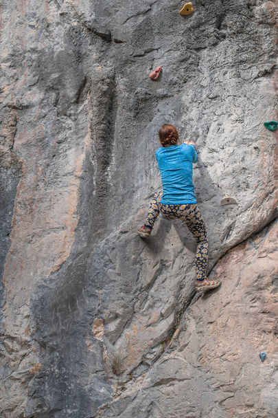 Young girl climbing up the rock in Turkey - Photo, Image
